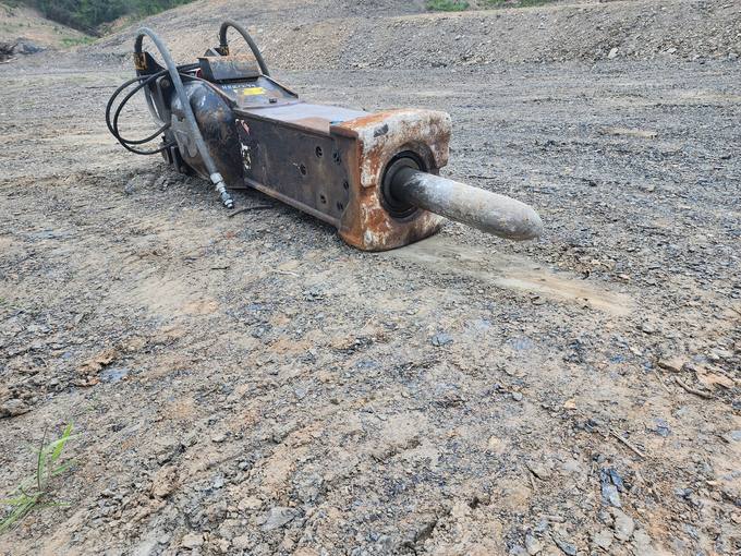 Hydraulic Rock Breaker Hammer Attachment on Excavated Bluff