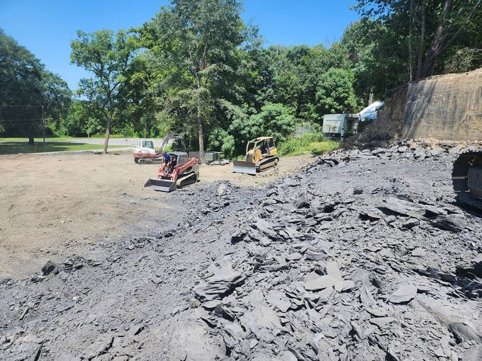 Engineered Poured-Concrete Retaining Wall Built Into Cut Rock Bluff