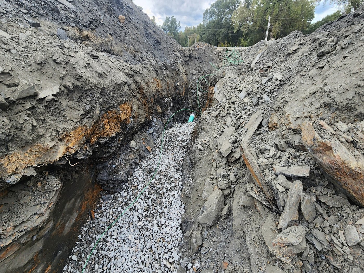 Deep Rock Utility Trench with Precast Concrete Manhole and Water Main