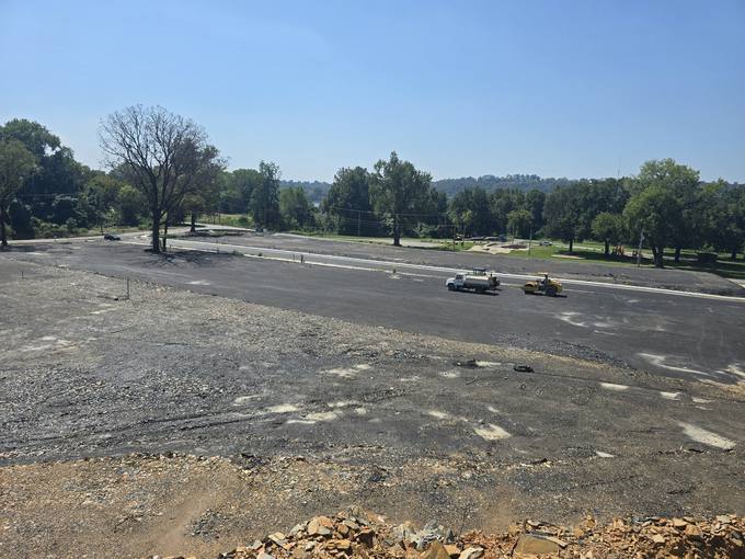 Active Hot-Mix Asphalt Paving on Emerald Drive Overlooking River Valley